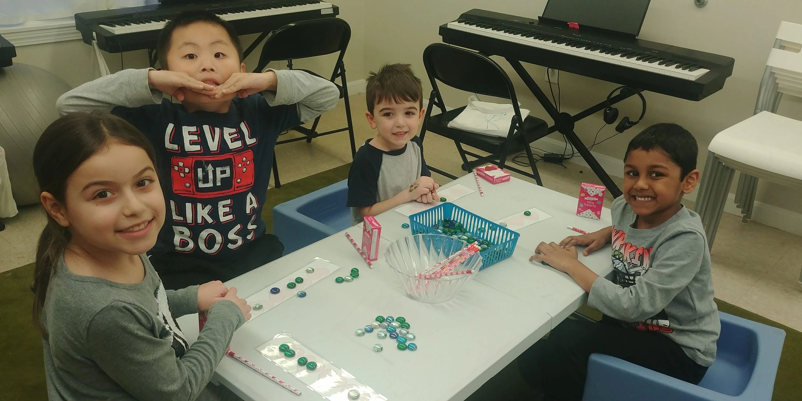 Children learning activity at table with keyboards